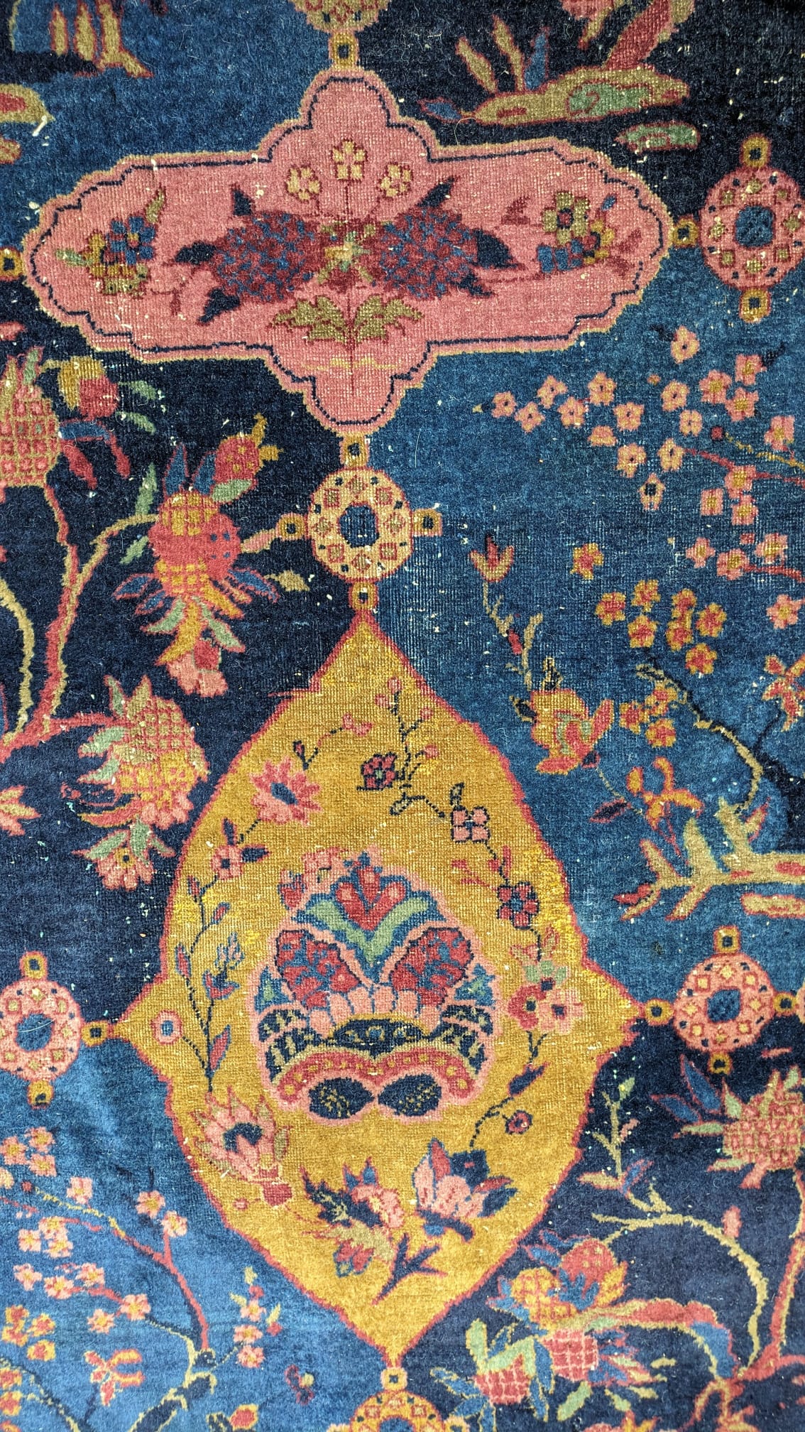 A Khorasan Mashhad red ground carpet, circa 1930’s, with field of stylised floral motif medallions, multi-bordered, 545 x 400cm. Condition - fair